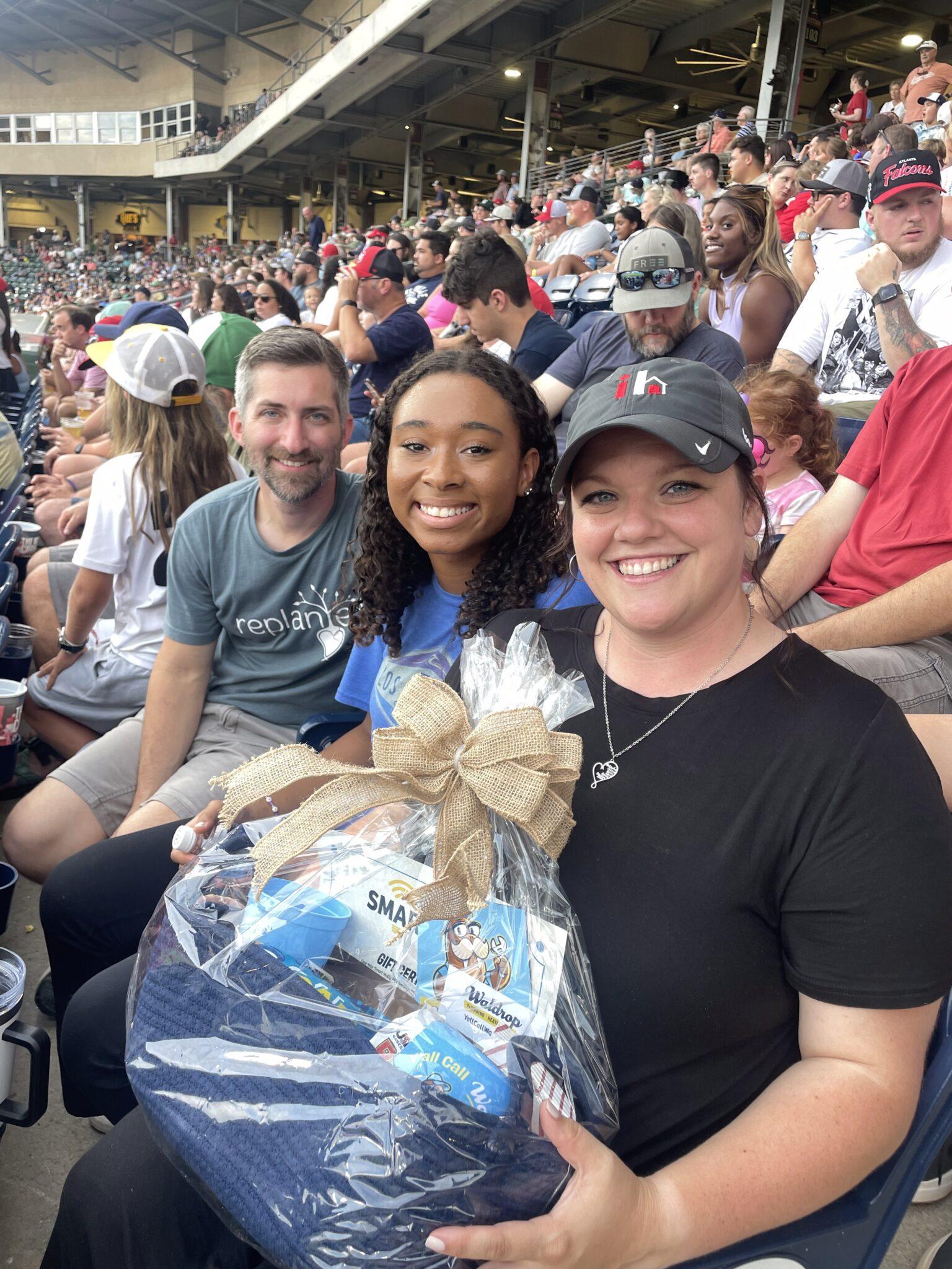 Friends of Isaiah House in Greenville in the stands with a gift basket from Waldrop
