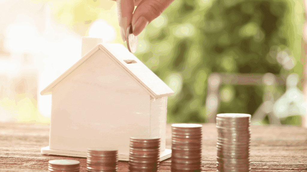 house piggy bank with stacks of coins