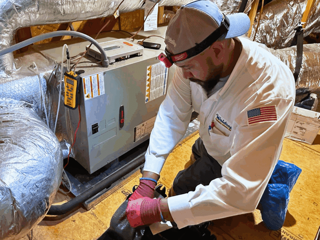 Technician in attic at furnace.
