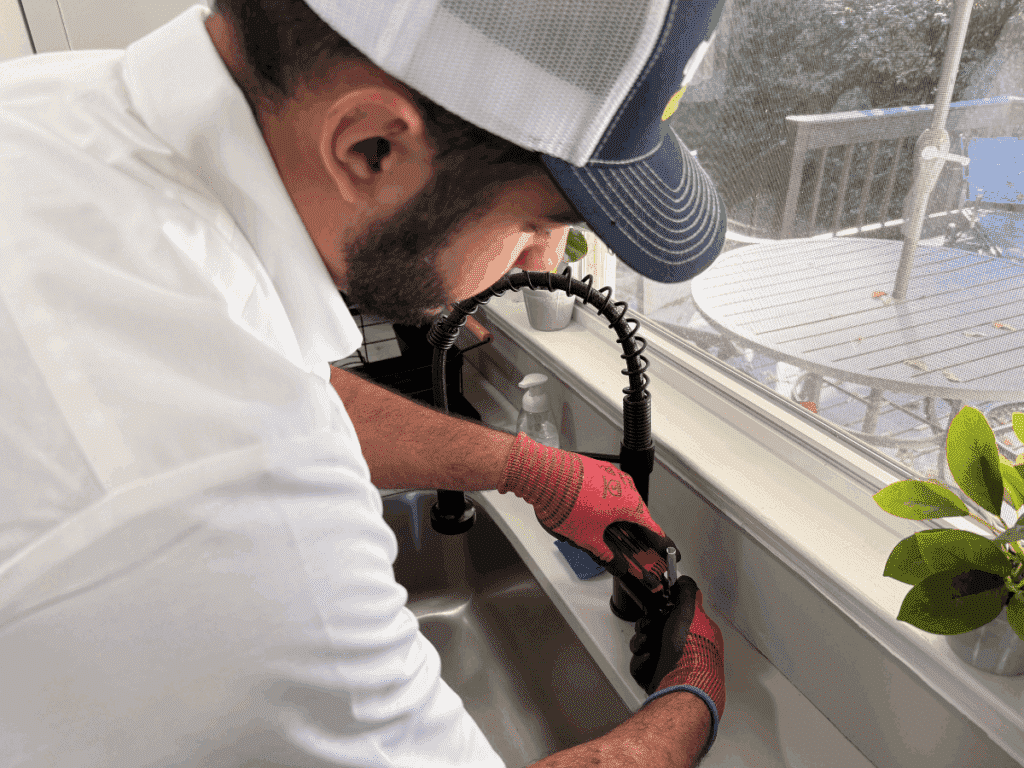 Plumber installing new sink
