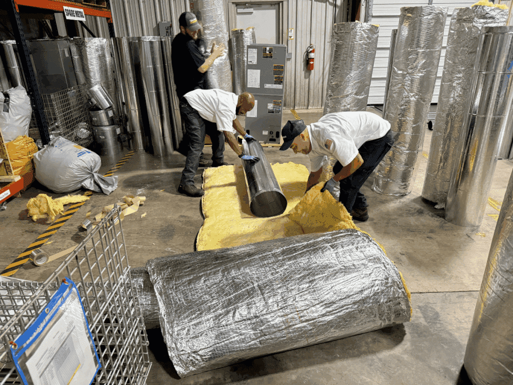 technicians preparing new duct work for install