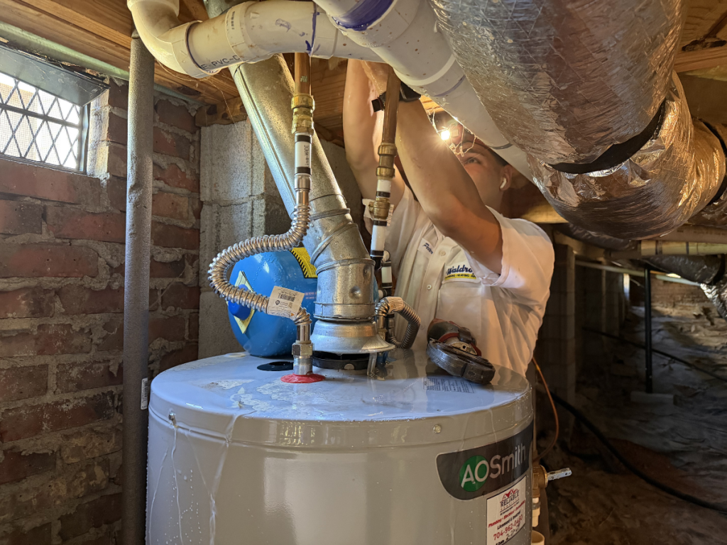 tech repairing a water heater