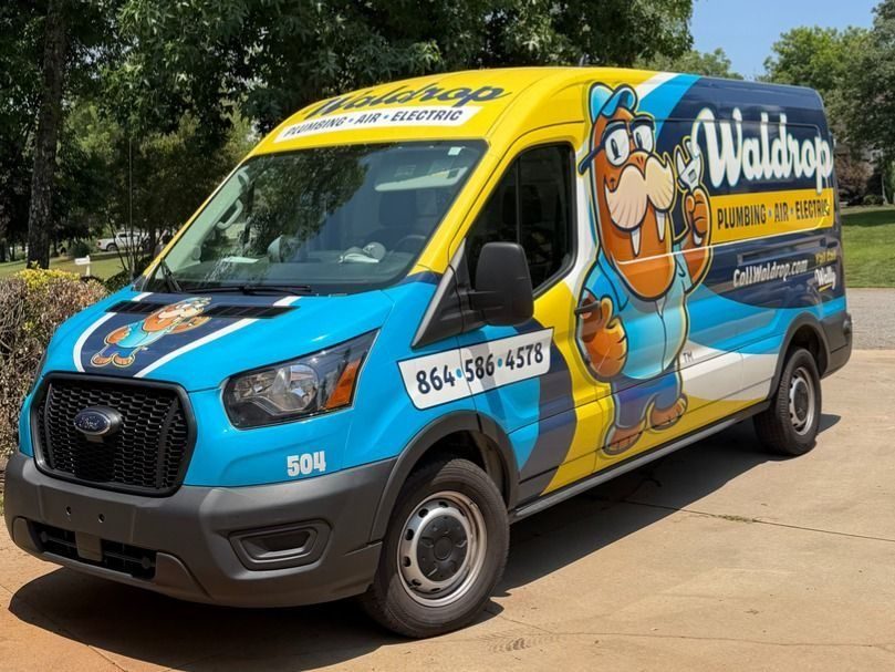 Bright blue–yellow service van with a cartoon beaver mascot advertising plumbing, HVAC, and electrical services; phone 864-586-4578.
