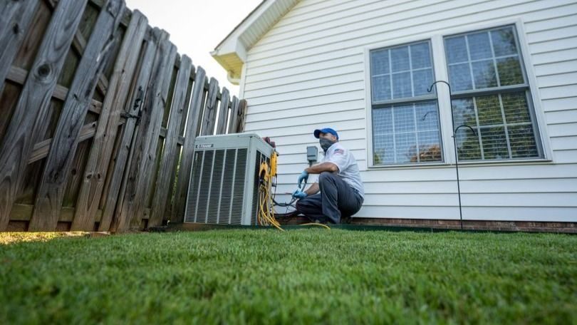 Waldrop technician working on a home heat pump