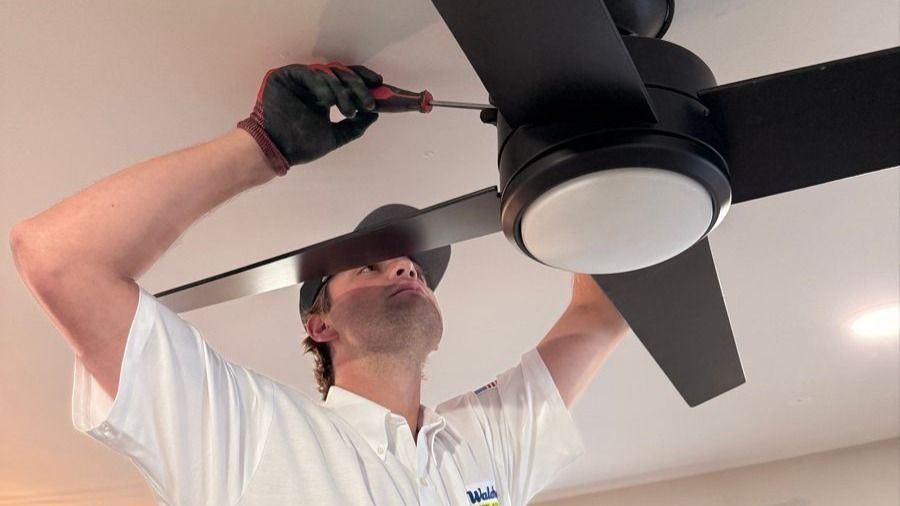 Waldrop electrician installing a ceiling fan