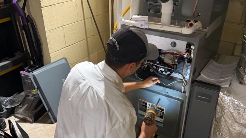 Waldrop tech conducting maintenance on furnace.