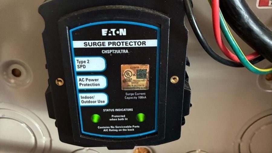 Eaton surge protector module mounted inside an electrical panel with status LEDs and labeled features for protection type and use