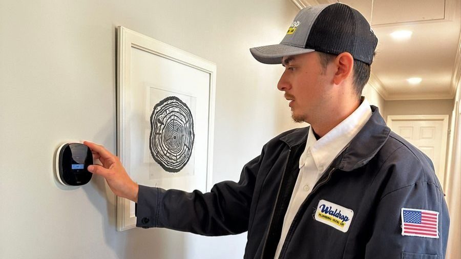 Waldrop technician programming a new thermostat