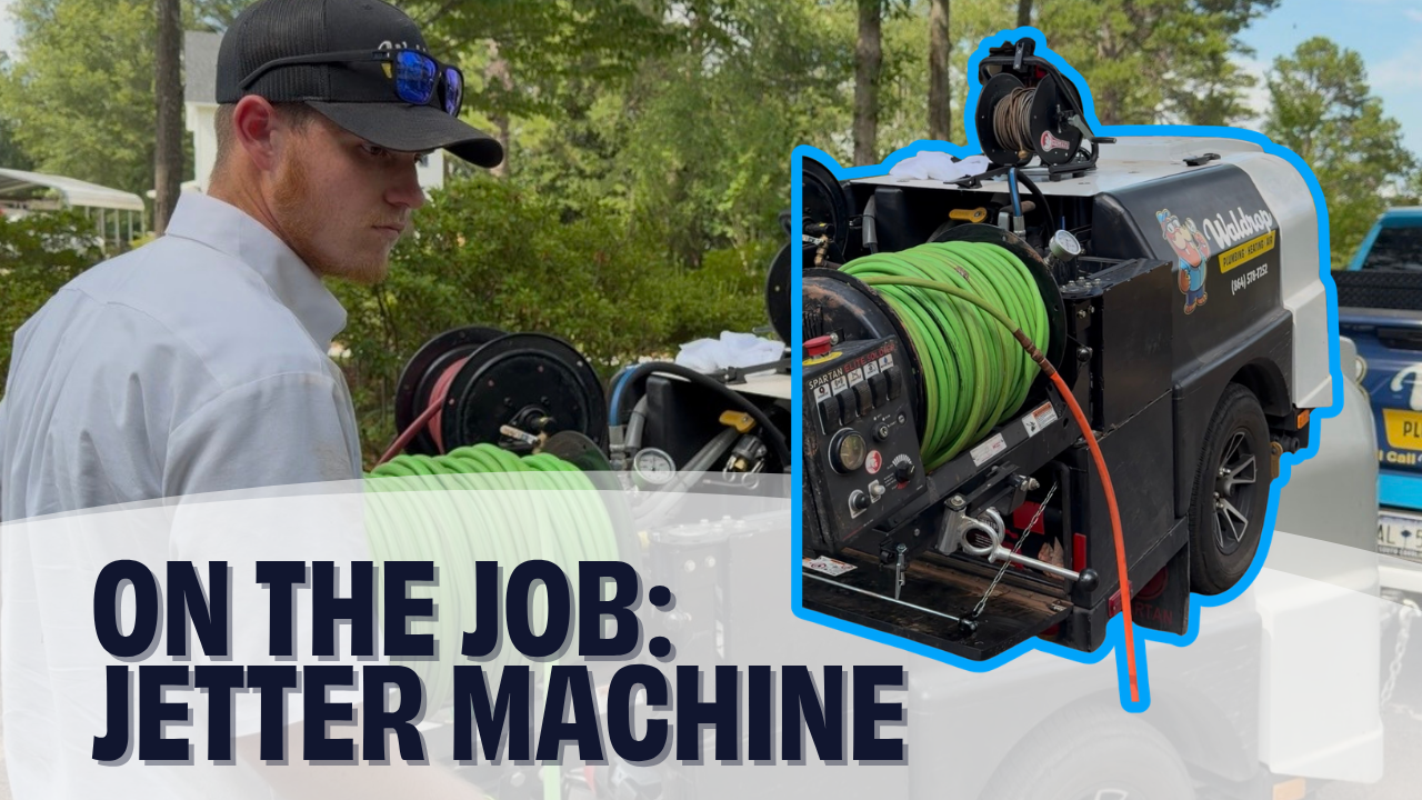 plumber using the jetter machine to clear a main water line clog.
