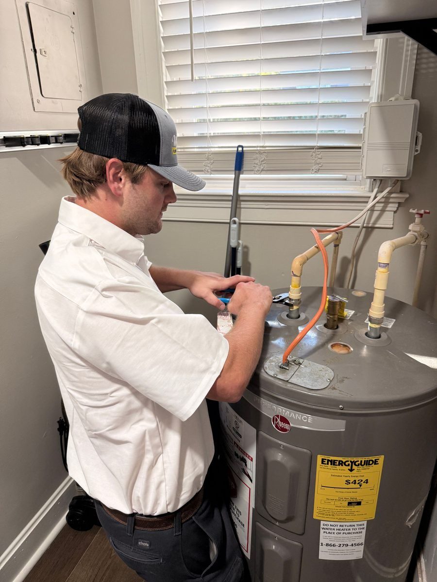 Plumber repairing water heater.